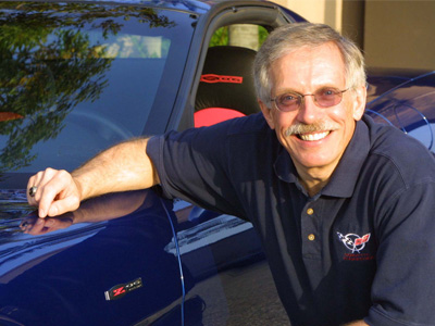 David Hill posing with a C5 Corvette. He was a chief engineer on the project