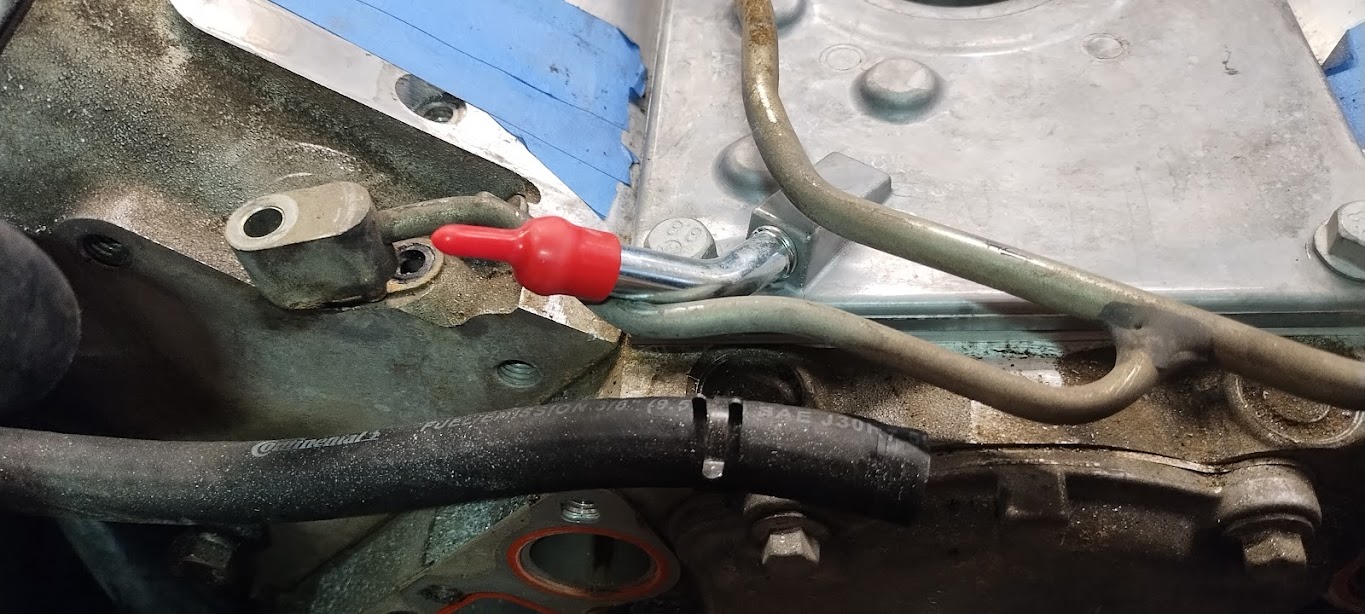 An LS6 Valley Cover in place on an LS1, with the LS1 Steam Port Crossover tubing on it to demonstrate where it collides with the LS6 Valley Cover
