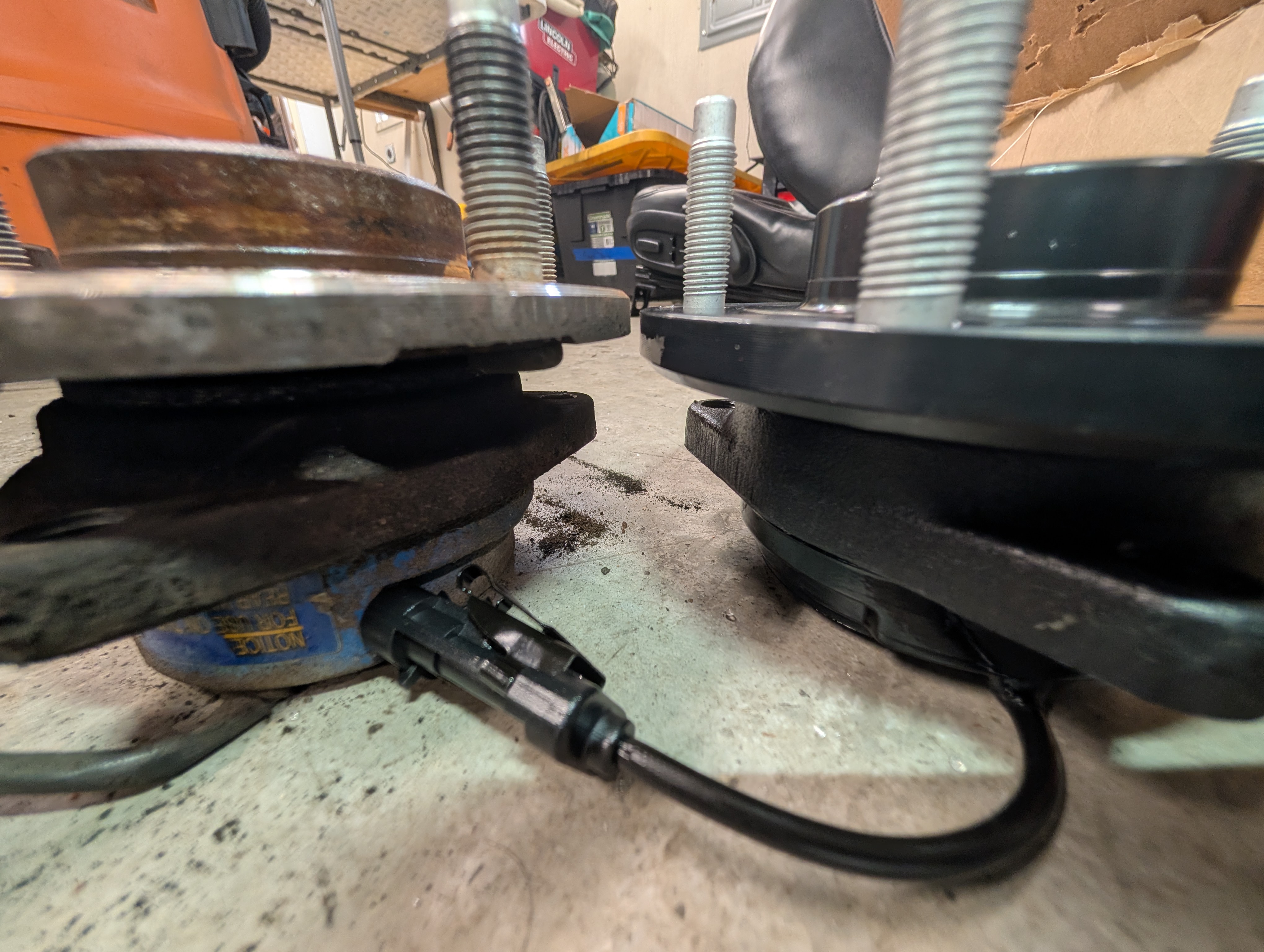 An OEM wheel bearing besides a Gen 3 MPI Racing wheel bearing, demonstrating much thicker construction.