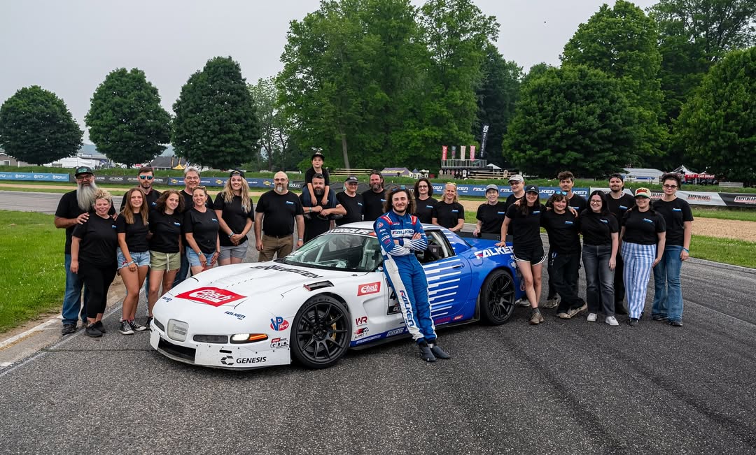 Matan Rosenberg posing with his entire team and their C5 Corvette