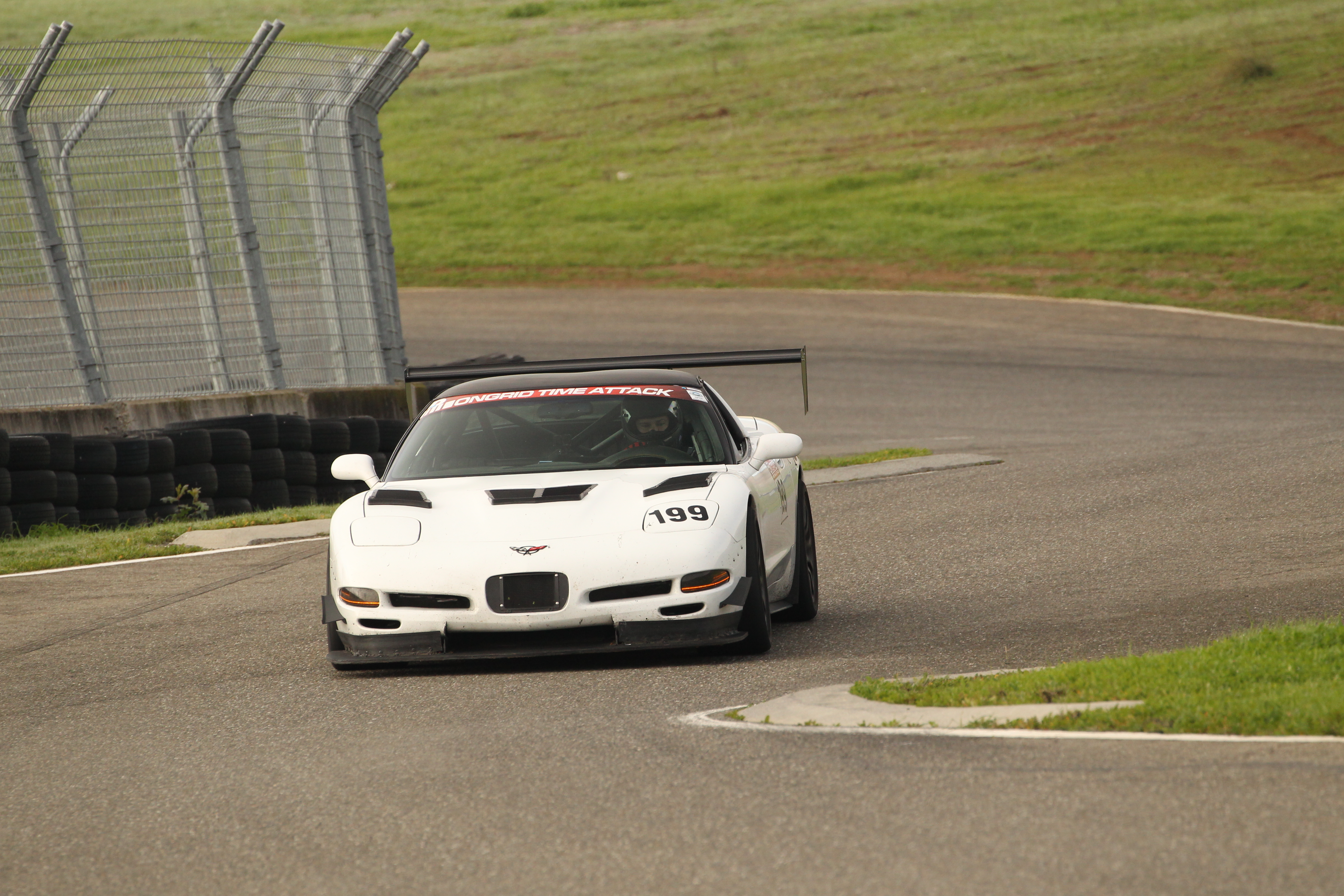 Shred Jesse's white C5 Corvette navigating the crossover at Thunderhill from West back to East