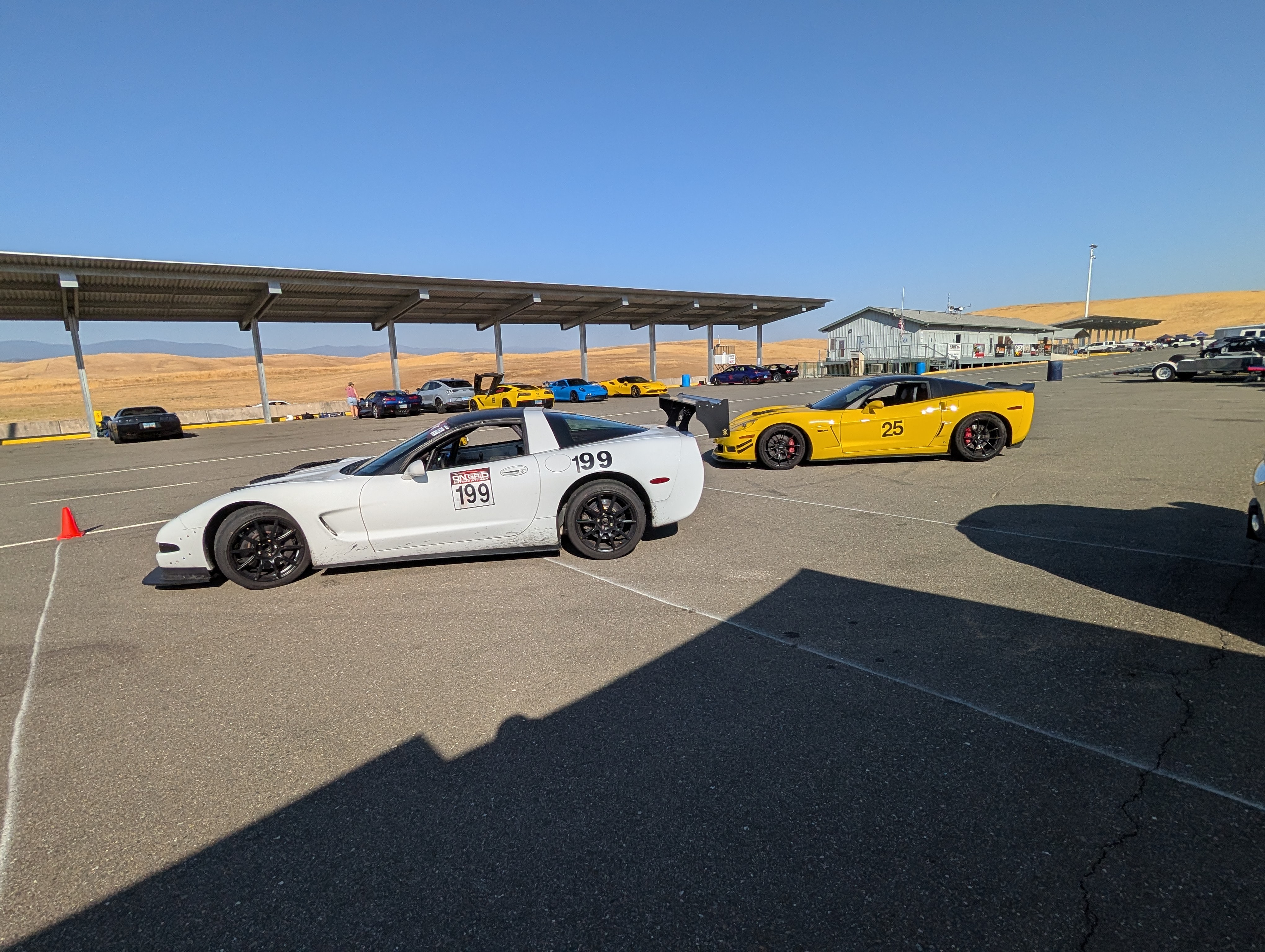 A White C5 corvette #199 and a Yellow C6 Corvette Z06 at Thunderhill West
