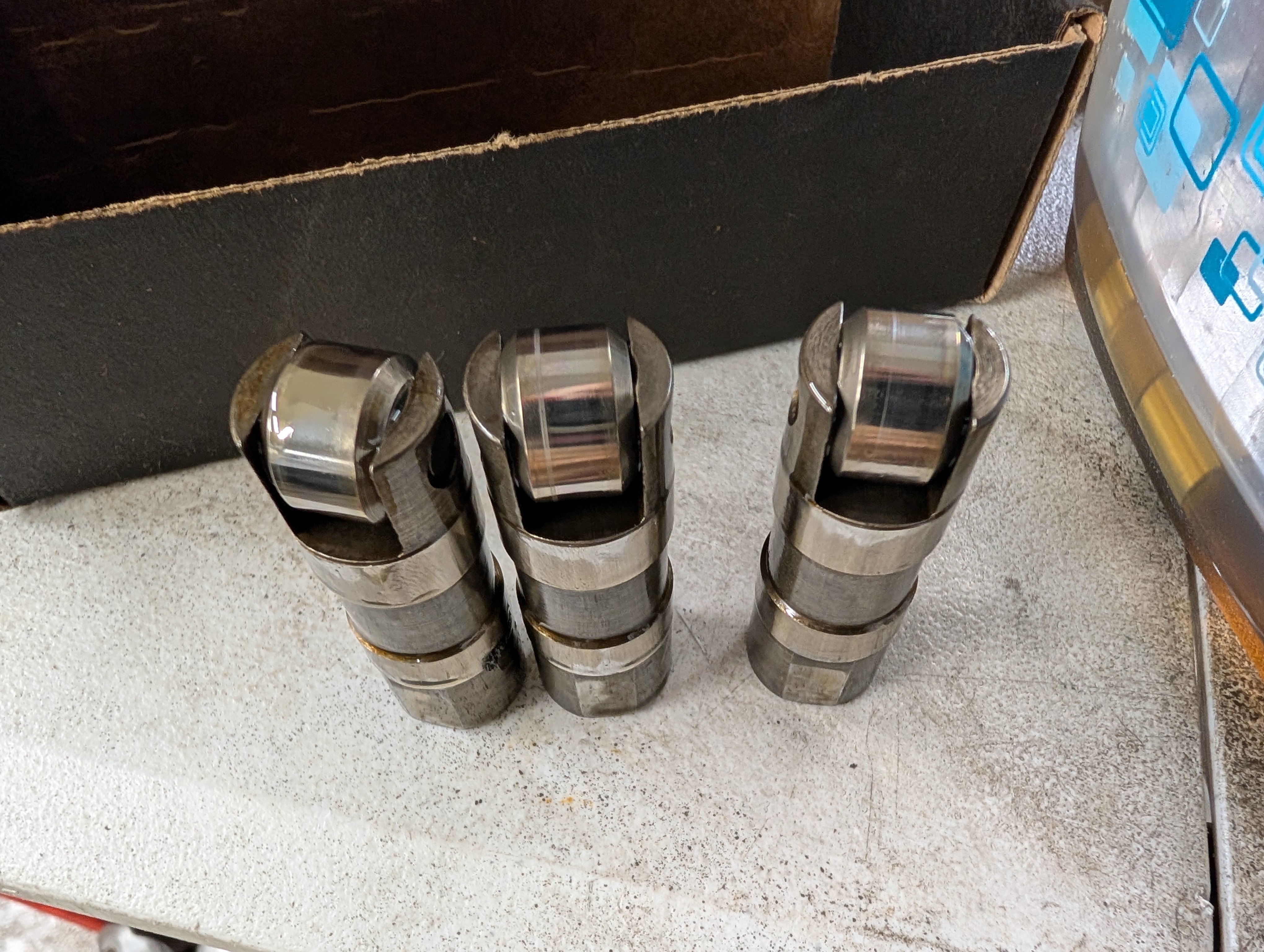 three of the factory LS1 lifters with small score marks on the rollers. This does not indicate an issue.