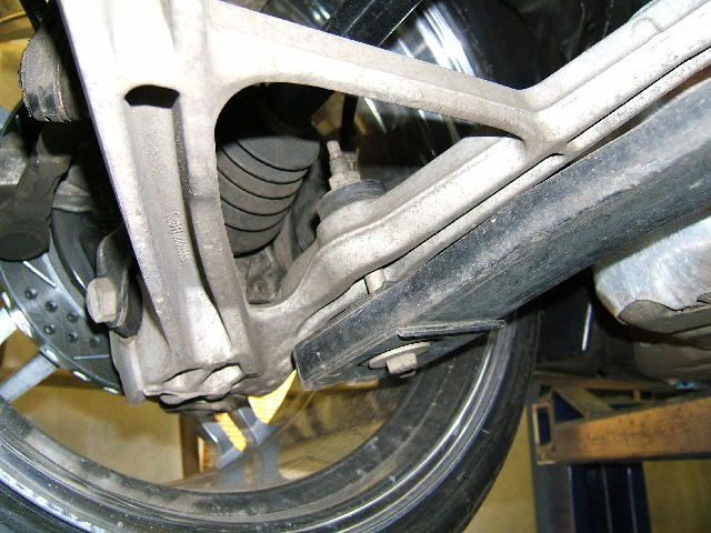 C5 Corvette rear lower control arm with an example of where the lowering bolt attaches