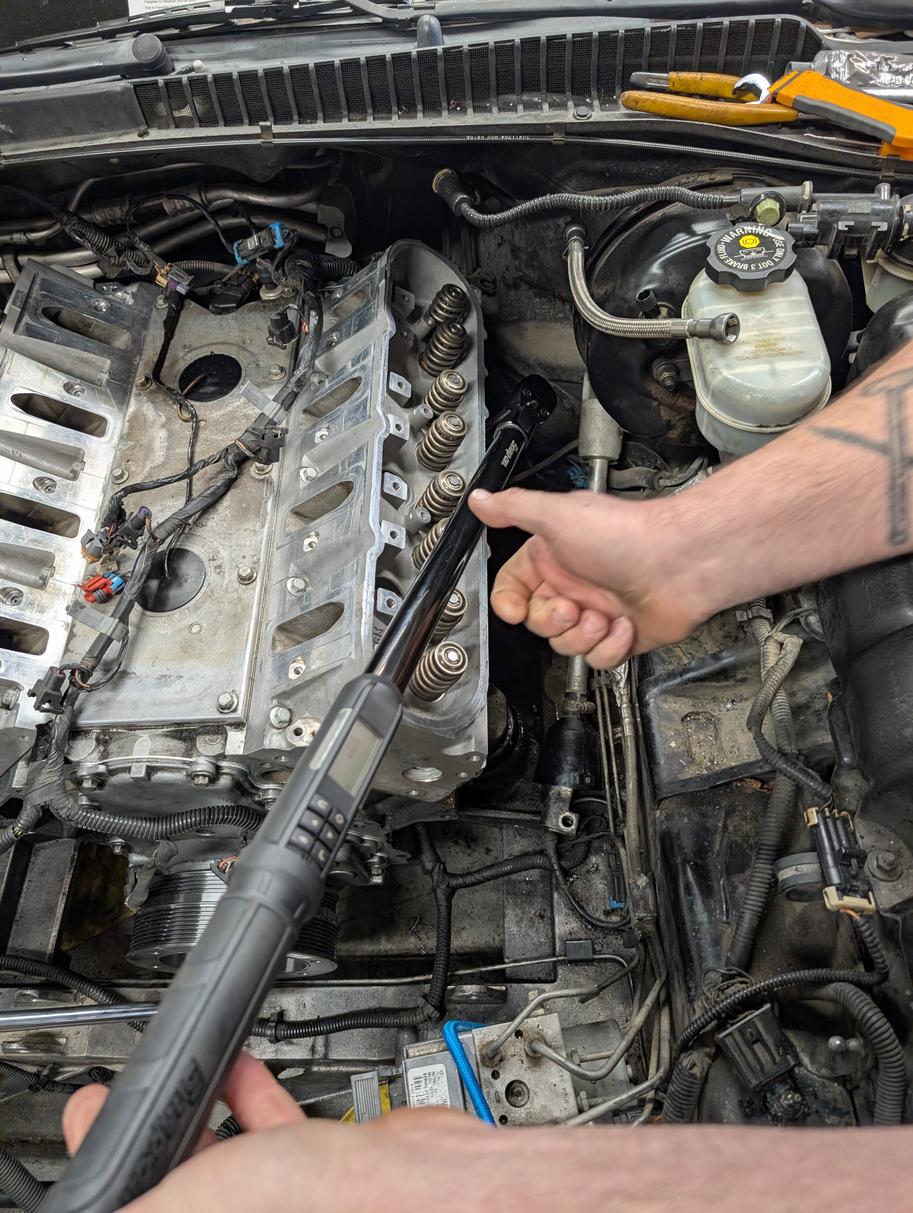 A picture of torqueing the head bolts on the dead to shred Ls1 drivers side head with a digital angle wrench