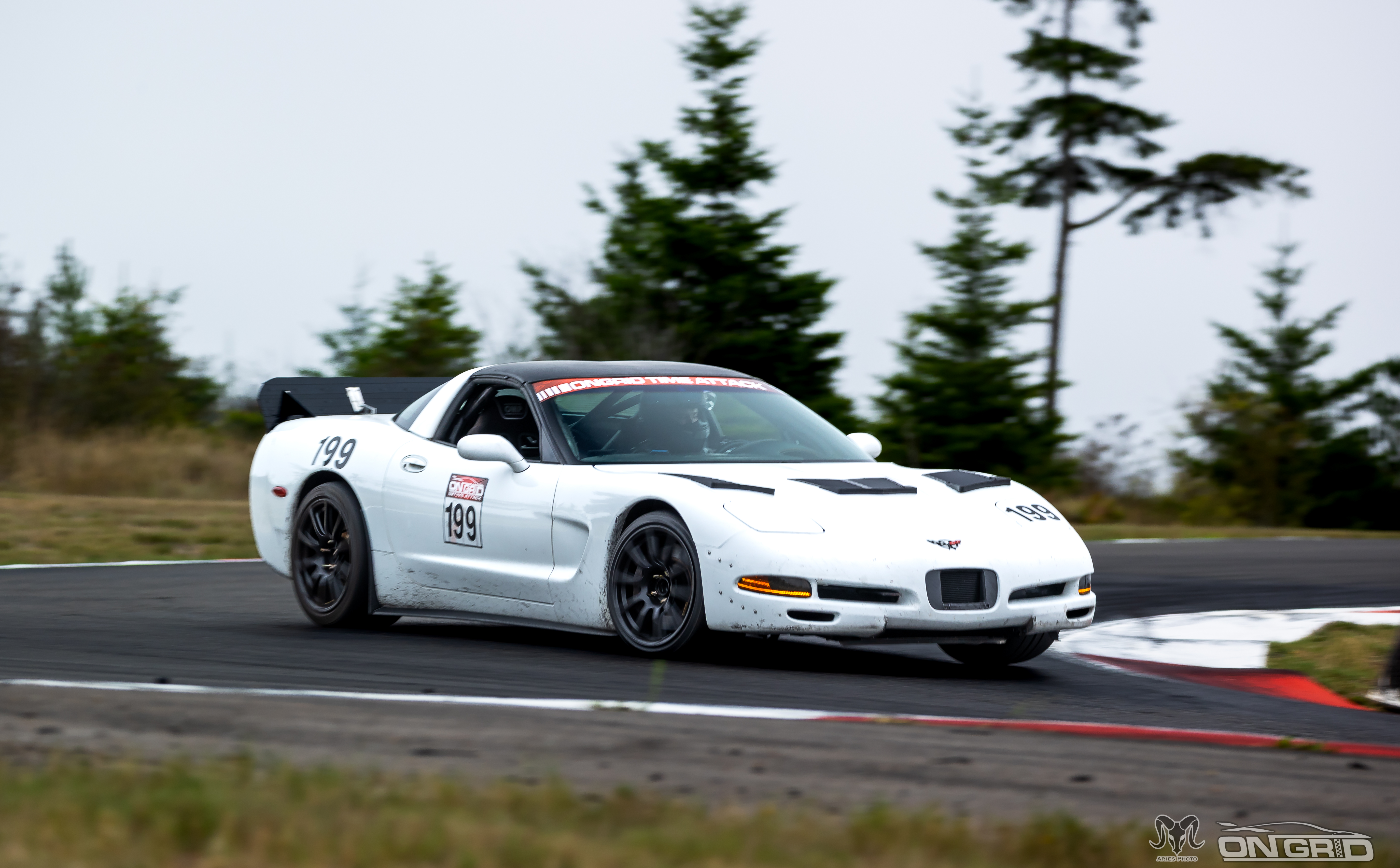 Shred Jesse's C5 Corvette making a sharp left hander, as seen from the front.