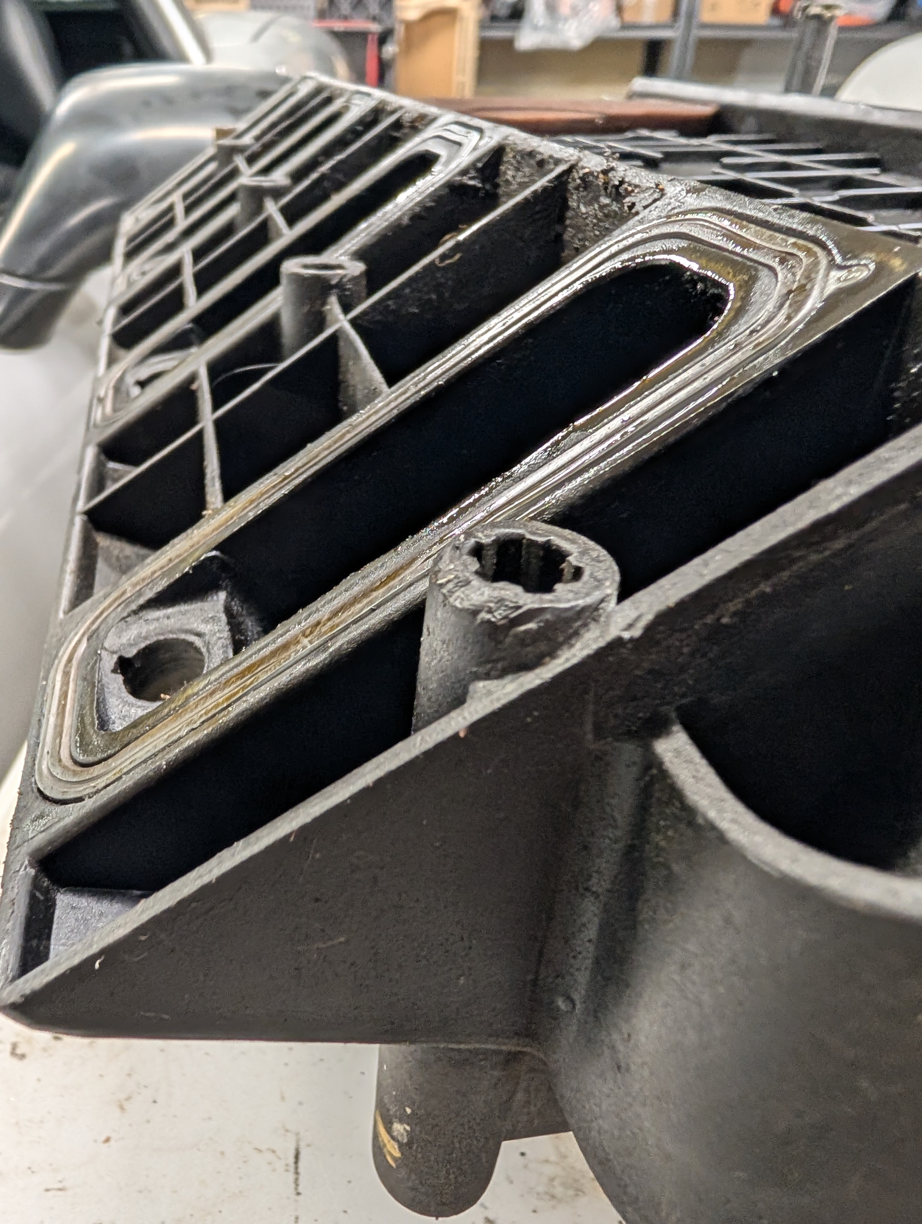 The ancient OEM gaskets of an LS1 intake manifold. They are flat to the intake manifold mounting surface.