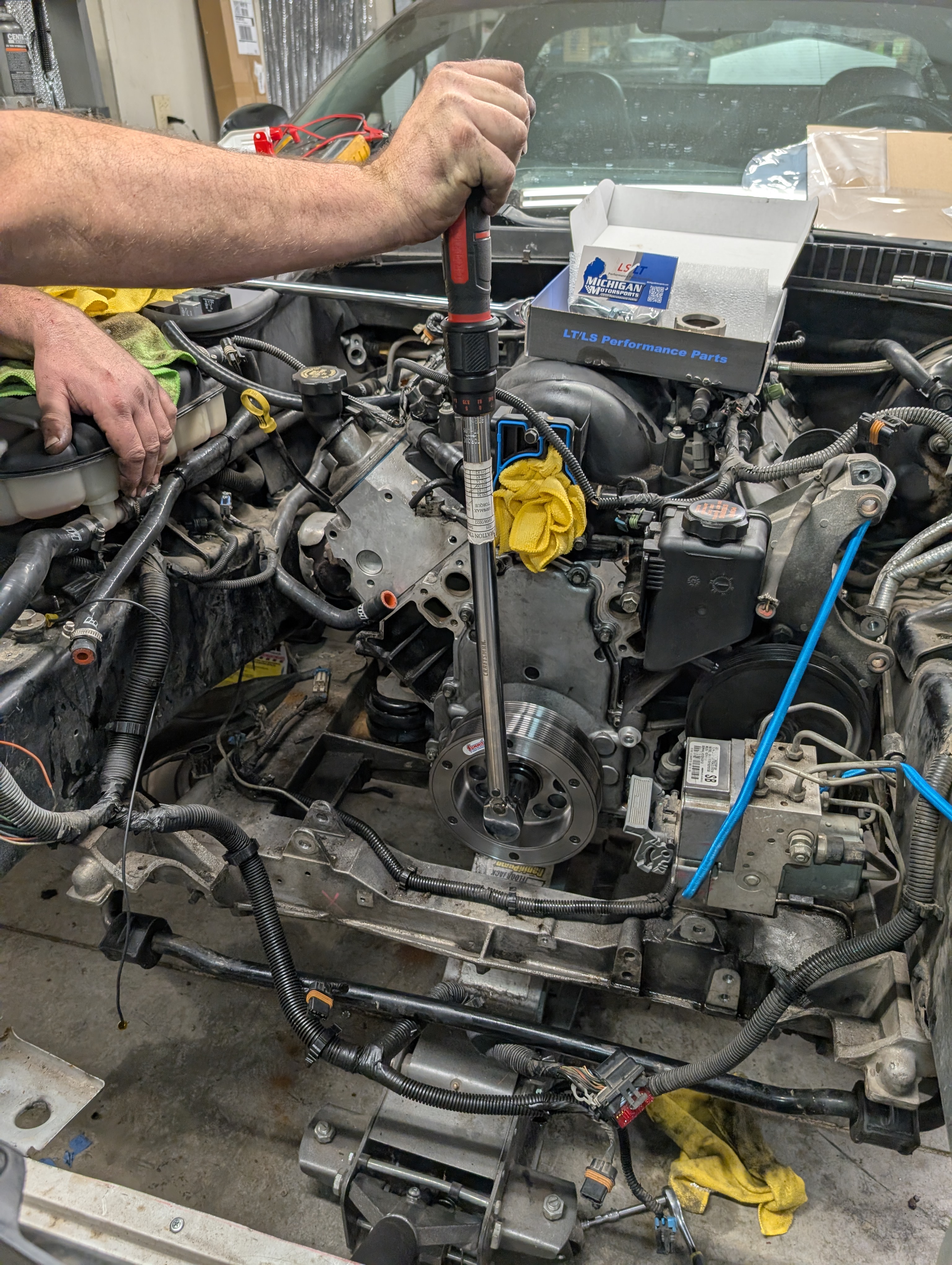 A large near 3 foot long torque wrench used to appy 235ftlbs of force onto the harmonic balancer of a C5 LS1