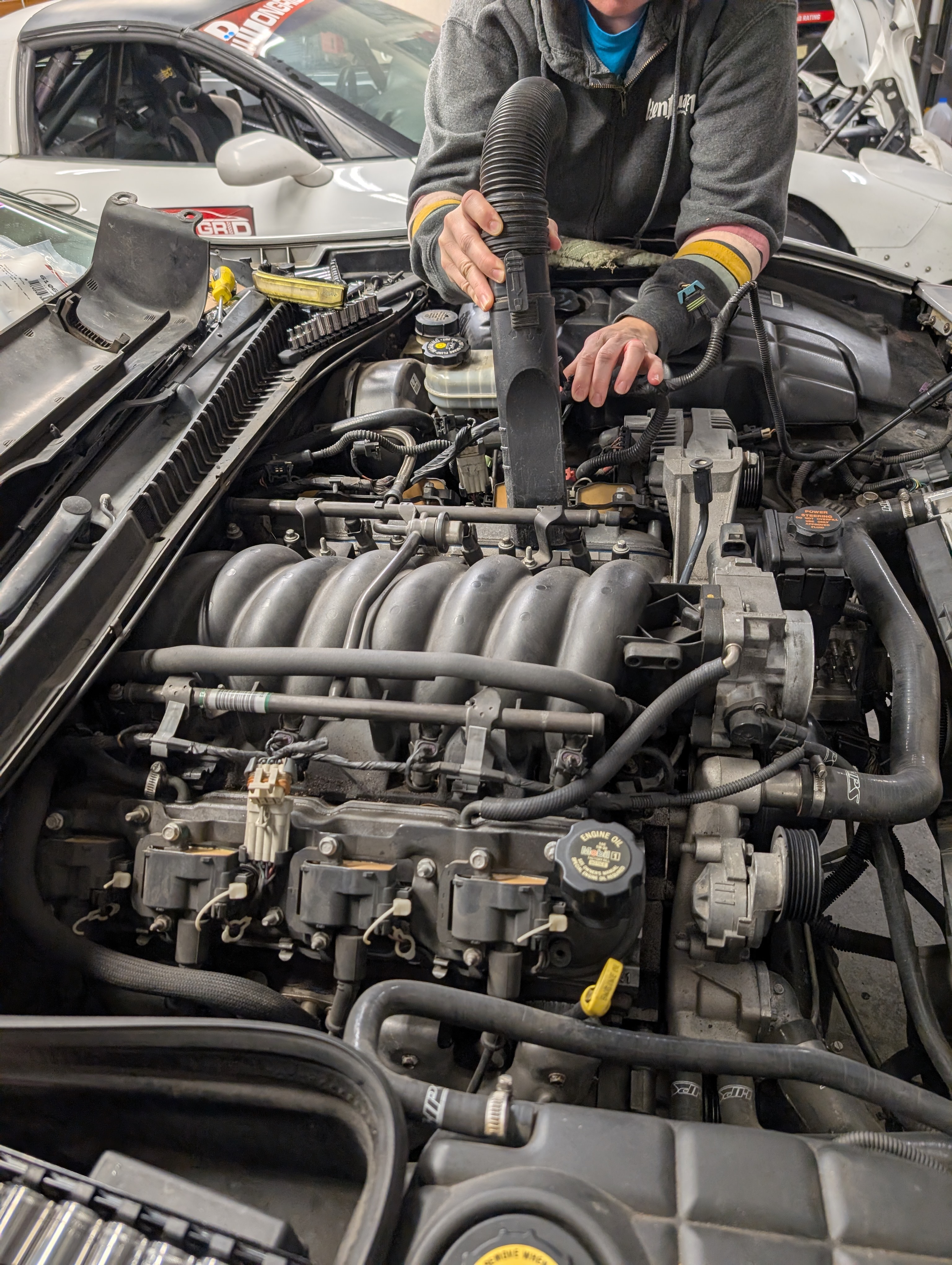 Cleaning the intake manifold area on a C5 Corvette LS1 engine before removal.