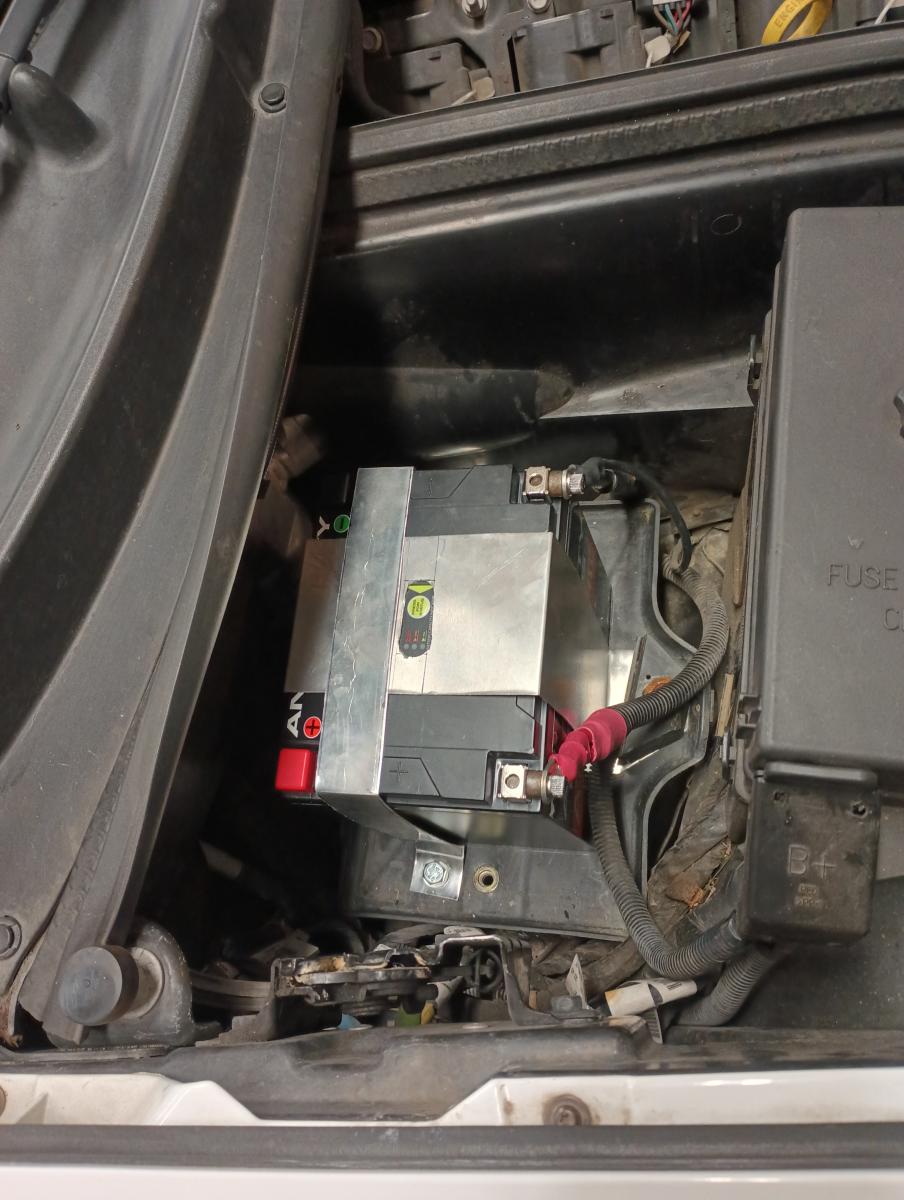 A C5 Corvette engine bay with an Antigravity ATX-30 battery installed, attached with some simple bent aluminum sheet metal