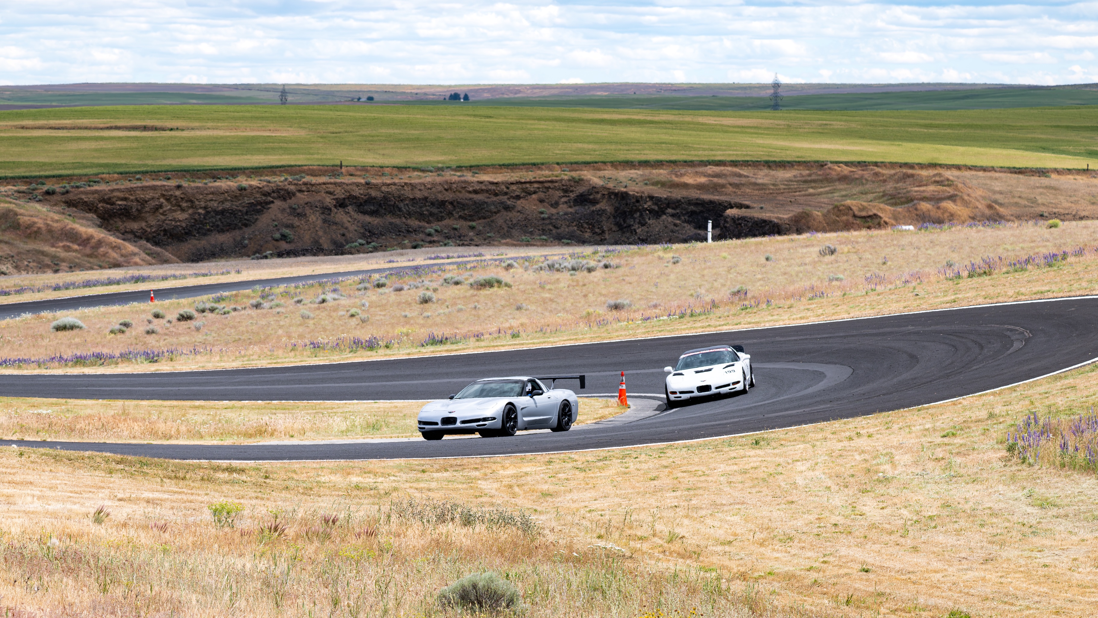 The dead to shred Corvette in front of Shred Jesse's white time attack C5 Corvette, entering the halfpipe.