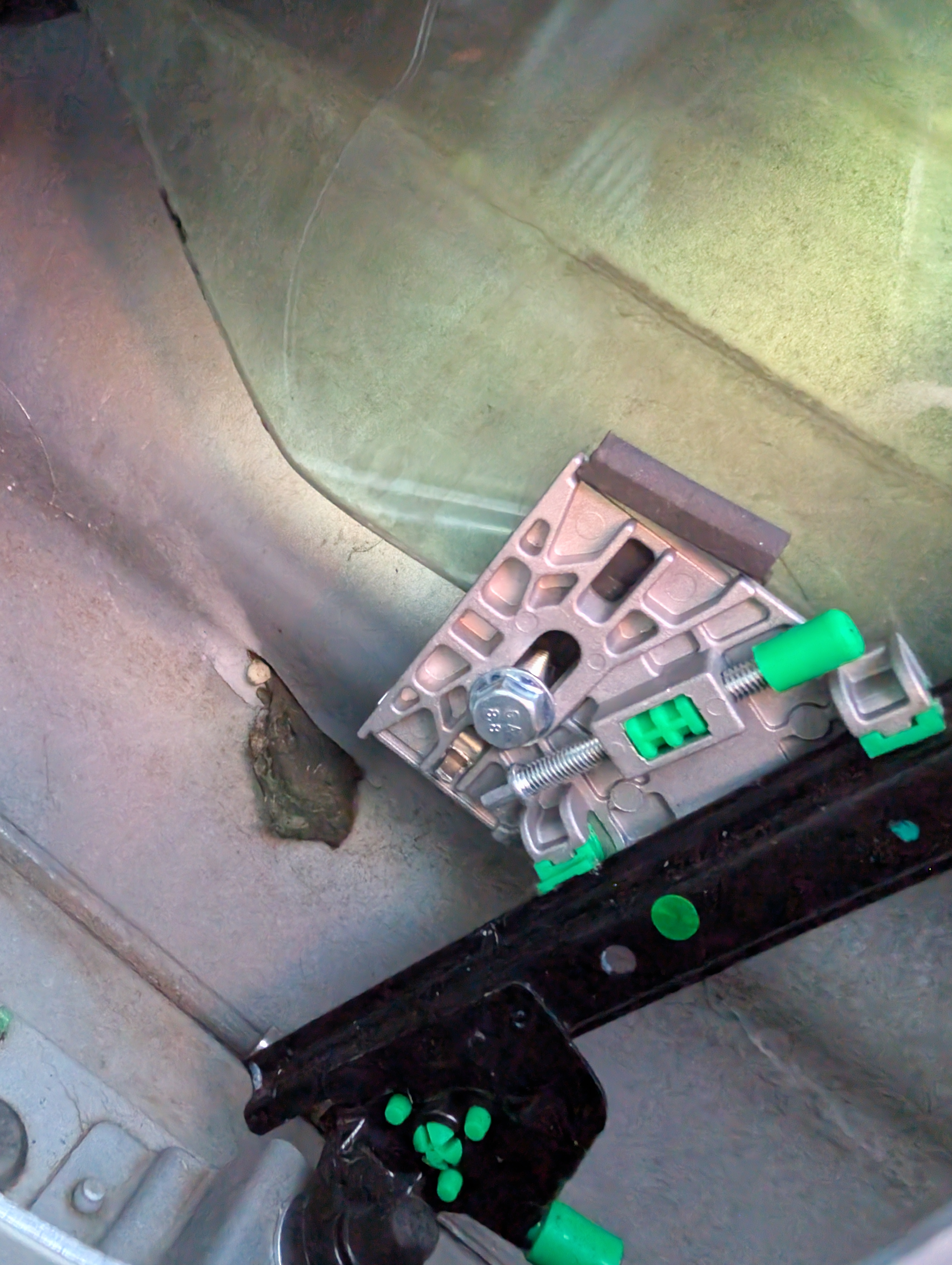 A picture of the window adjustment piece inside of a C5 Corvette door