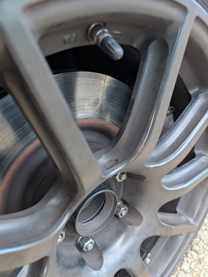 A cracked C6z06 rotor on the Dead to Shred 2001 C5 corvette, as pictured looking through the wheel spokes on the car
