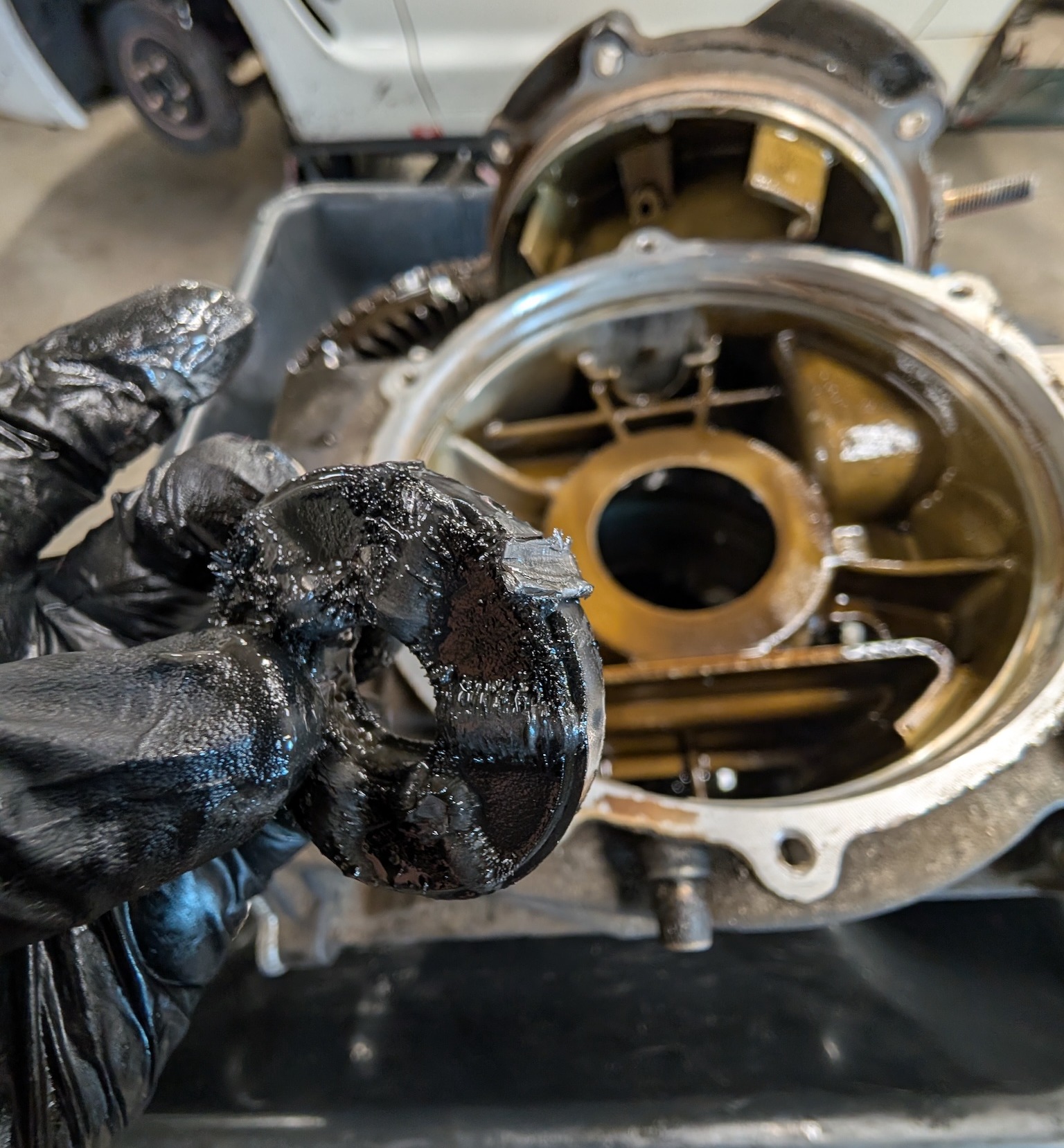A magnet from the inside of a C5 Corvette differential covered in magnet goop and featuring a broken chunk of metal that has found it's way to the magnet