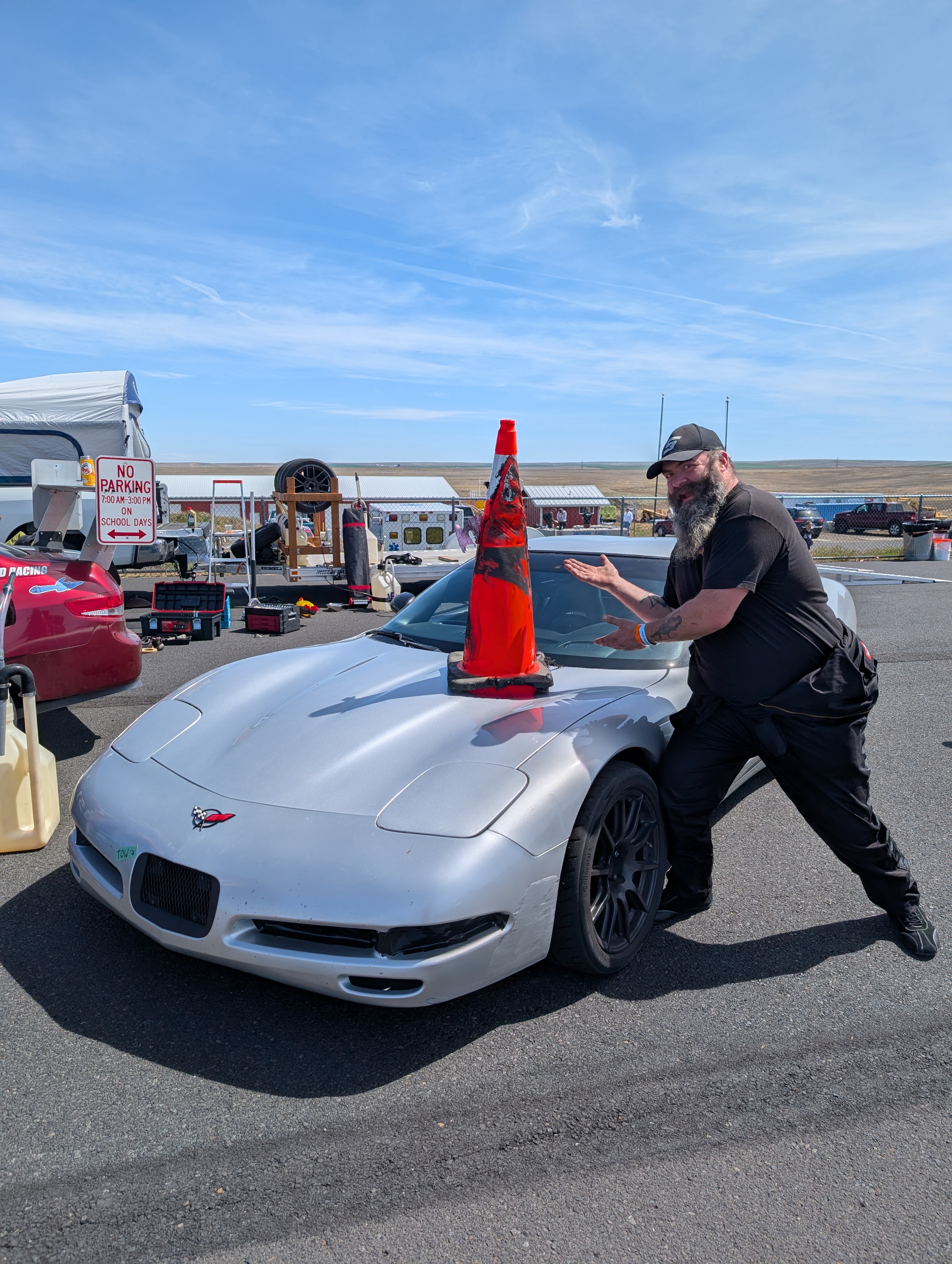 Dave, the team Fabricator, posing with the road cone he purchased after nuking it at the track.