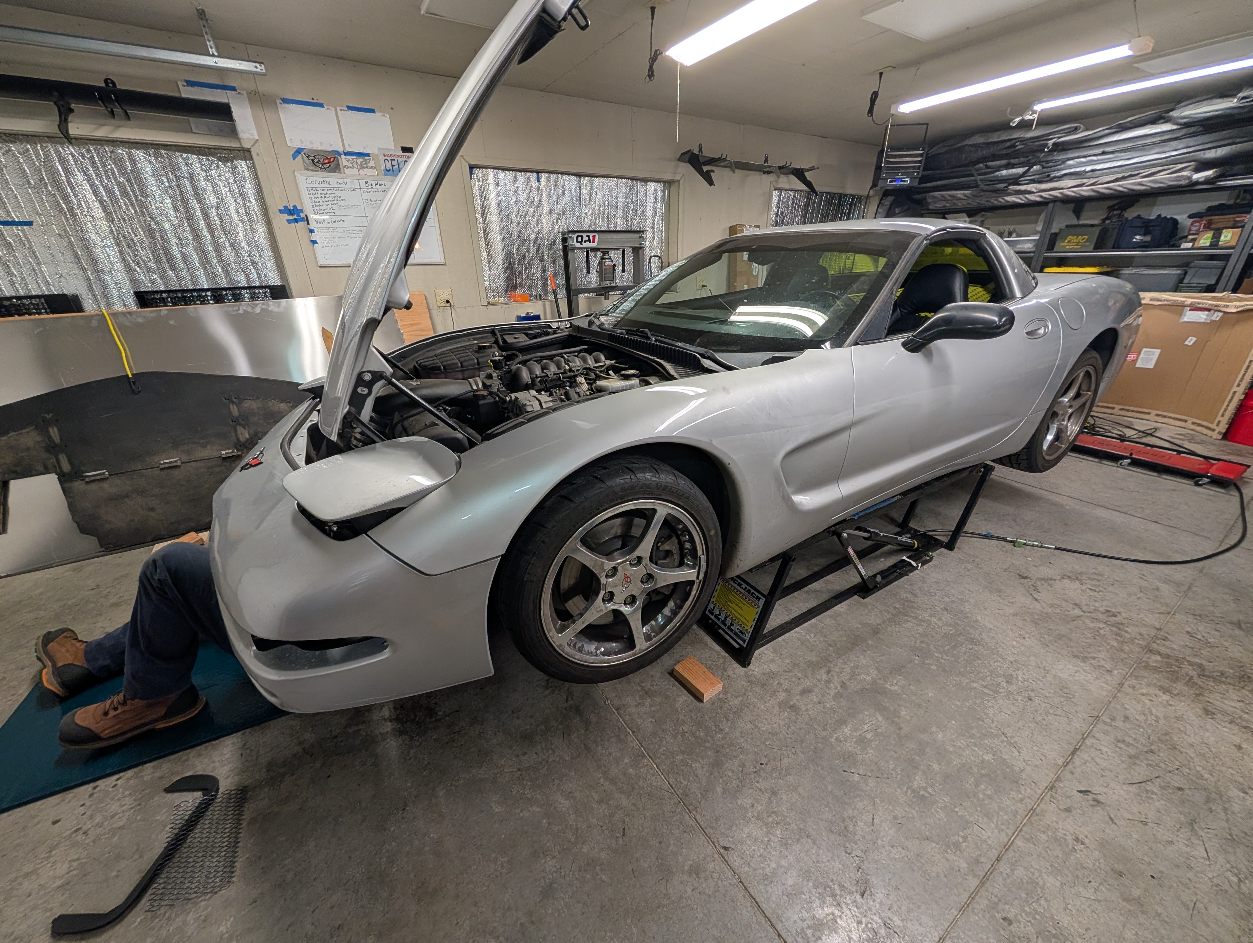 Dead to Shred Corvette up on QuickJacks with Dave's feet stick out from under the Corvette