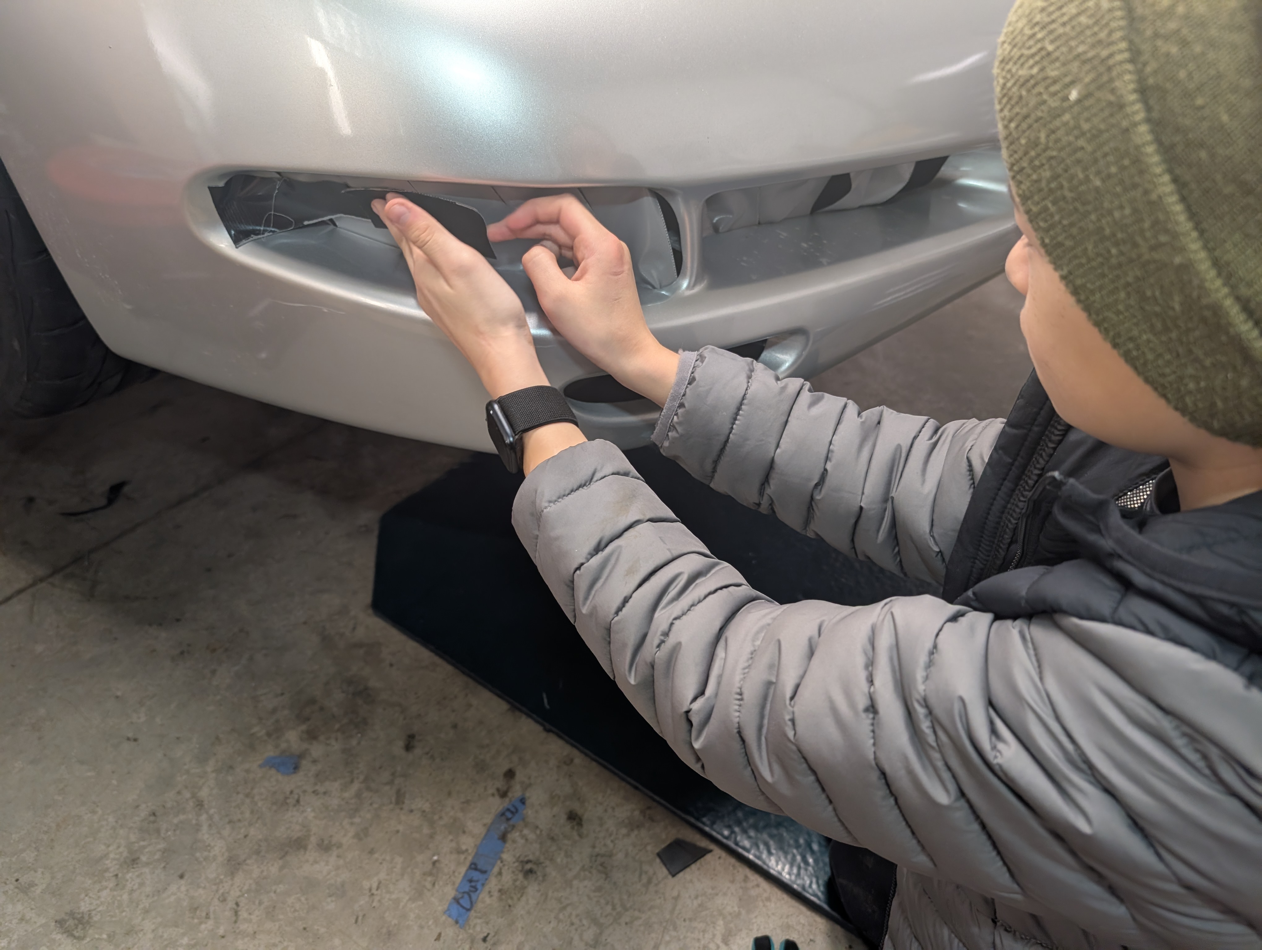 One of our team members kids helping to put gorilla tape on the front bumper... a highly technical and necessary piece that will keep air from entering the car where it shouldn't!
