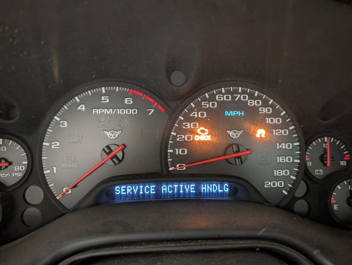 A C5 Corvette dash displaying the dreaded "Service active hndlng" message indicating a possible EBCM issue.