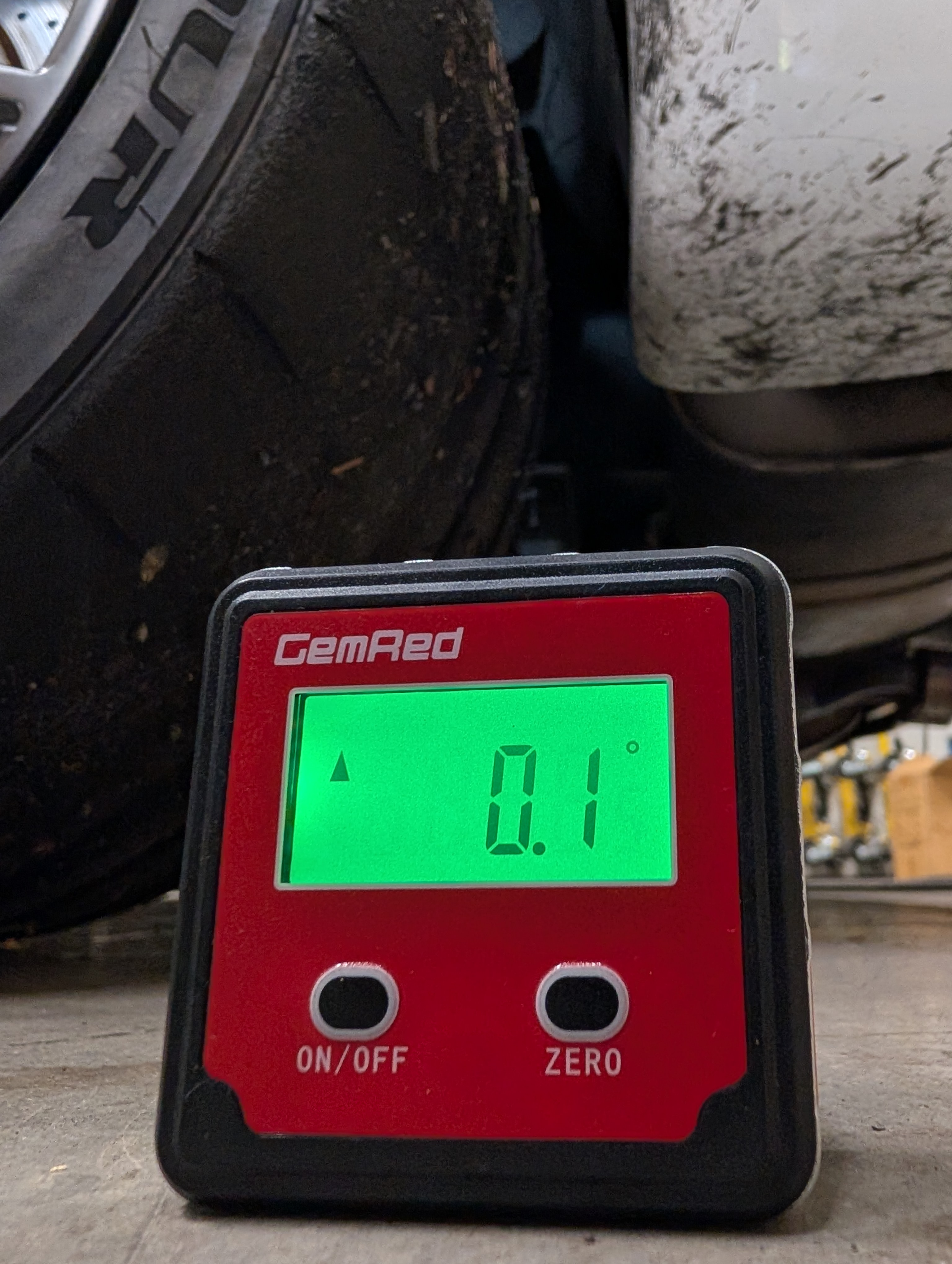 Angle gauge being used to zero on the floor of the shop.