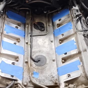 An LS1 Valley Cover on an LS1 motor, with the Head Ports painters taped over.