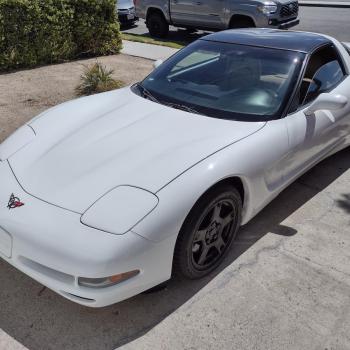 A White C5 Corvette sitting in a driveway.