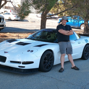 C5 Corvette Blogger Shred Jesse posing in front of his white 1999 C5 Corvette
