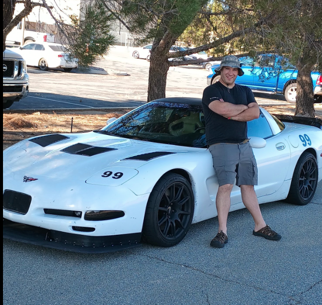 C5 Corvette Blogger Shred Jesse posing in front of his white 1999 C5 Corvette