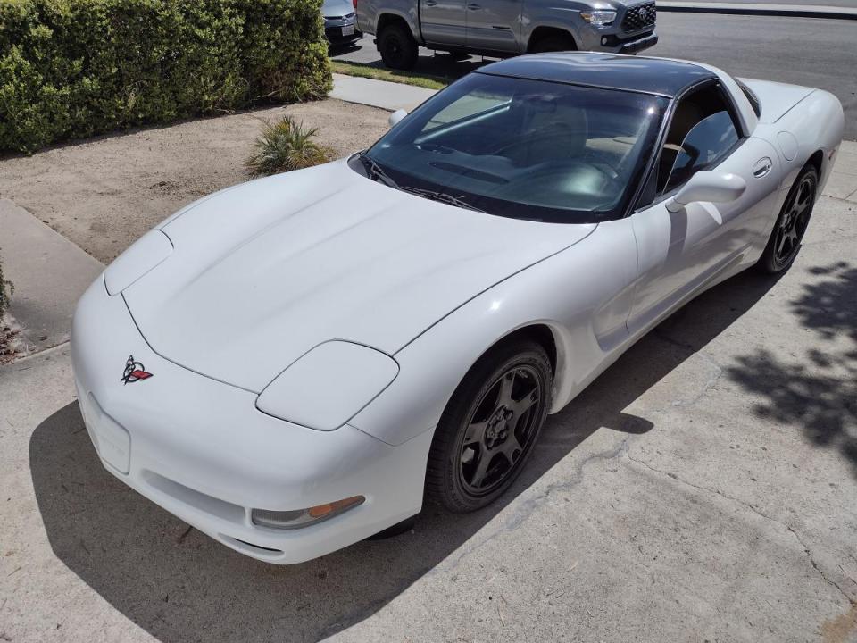 A White C5 Corvette sitting in a driveway.